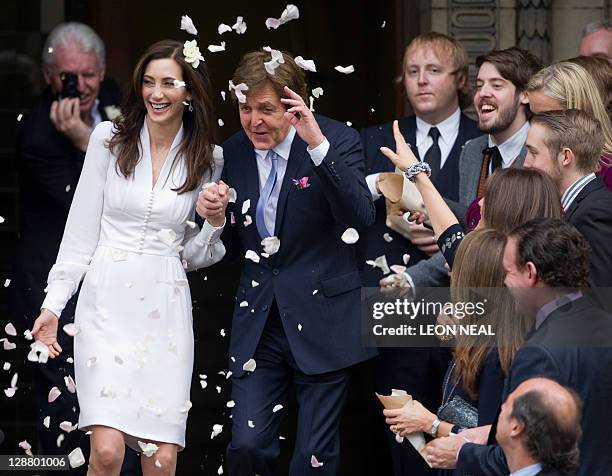 Paul McCartney and his new wife Nancy Shevell wave to fans as the leave Marylebone registry office in central London following their wedding on...