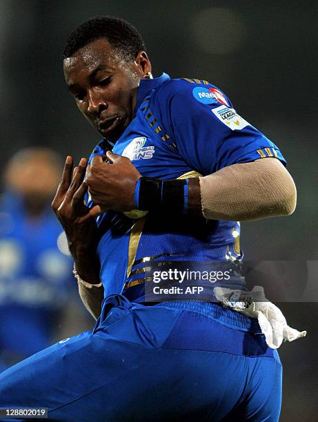 Mumbai Indians fielder secures the ball while taking the catch that dismissed Royal Challengers Bangalore batsman Mayank Agarwal during the Champions...