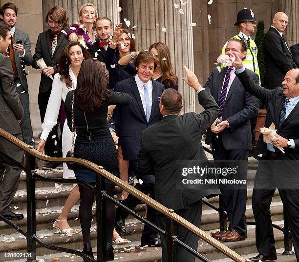 Sir Paul McCartney and Nancy Shevell leave the Marylebone Registry Office after their civil ceremony marriage on October 9, 2011 in London, England.