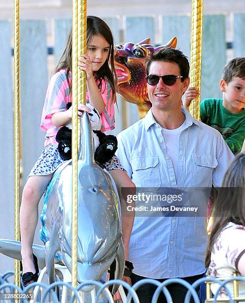 Suri Cruise and Tom Cruise visit Schenley Plaza's carousel on October 8, 2011 in Pittsburgh, Pennsylvania.