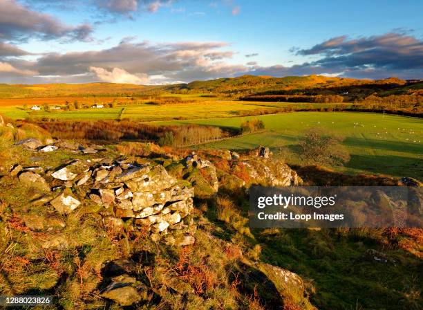 An autumn view of the farmland surrounding Dunadd Fort hillfort in a remote part of the Scottish Highlands.