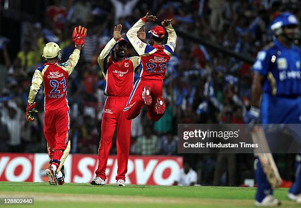 Royal Challengers Bangalore players celebrate after the dissmisal of Mumbai Indians batsman Ambati Rayudu during the Champions League Twenty20 Final...