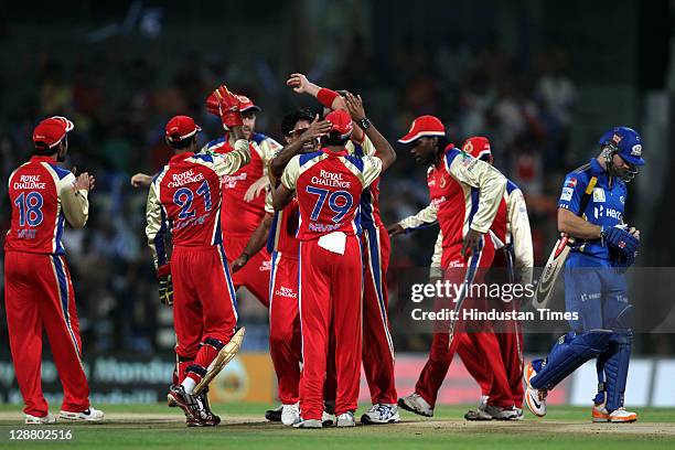 Royal Challengers Bangalore team-mates celebrate after the dissmisal of Mumbai Indians batsman Aiden Blizzard during the Champions League Twenty20...