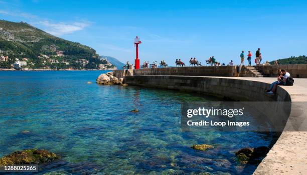 People relaxing on the porporela at Dubrovnik.