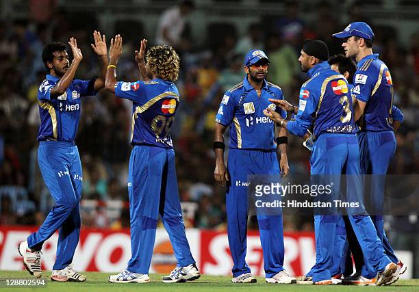 Mumbai Indians players celebrate after the dissmisal of Royal Challengers Bangalore batsman Tilakratne Dilshan during the Champions League Twenty20...