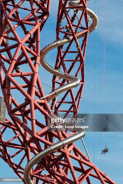 An abseiler descends to the bottom of the ArcelorMittal Orbit sculpture slide in the Queen Elizabeth Olympic Park, Stratford.