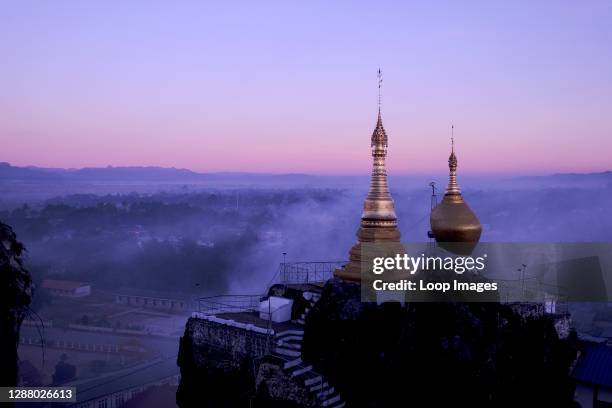 Dawn breaks over golden stupas at Taung Kwe pagoda in the city of Loikaw in Myanmar.