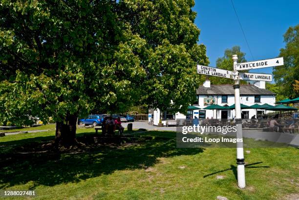 Signpost outside the Britannia Inn Elterwater.