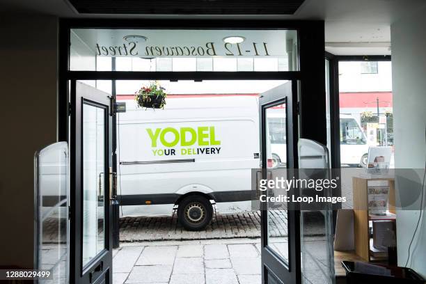 Yodel delivery van vehicle parked outside a shop store in Truro City centre in Cornwall.