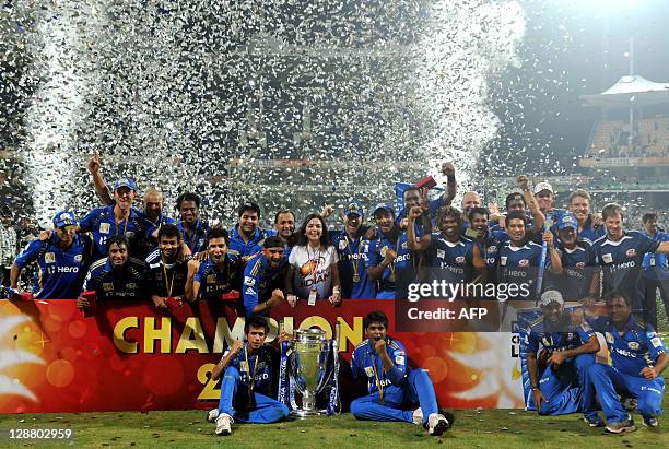 Mumbai Indians players along with team Owner Tina Ambani celebrate after winning the Champions League Twenty20 trophy after the final match between...