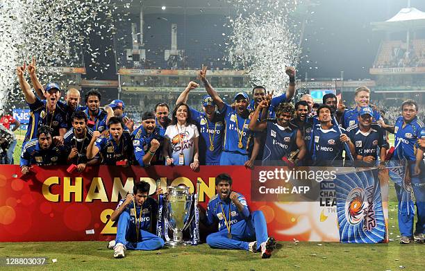 Mumbai Indians players along with team Owner Nita Ambani celebrate after winning the Champions League Twenty20 trophy after the final match between...