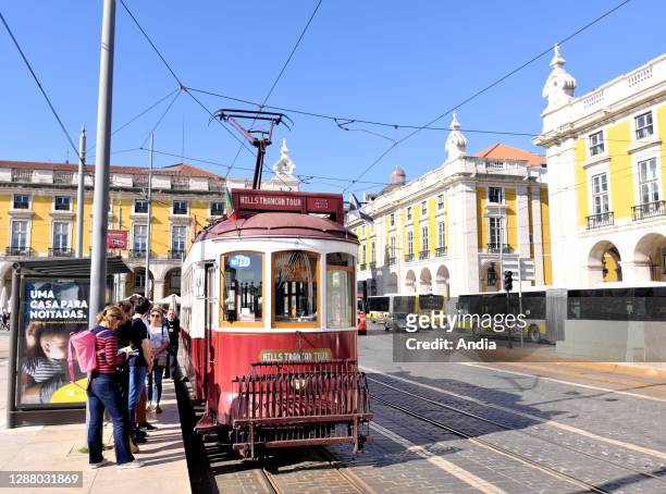 Tram in 'Praca Do Comercio' square. Modern tram with an advert to discover the city of Istanbul.