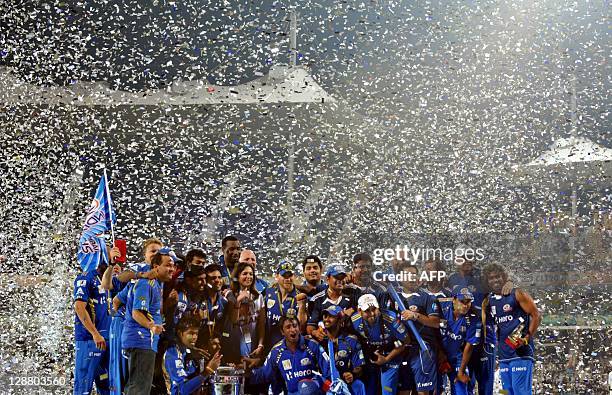 Mumbai Indians players along with team owner Tina Ambani celebrate after winning the Champions League Twenty20 trophy after the final match between...