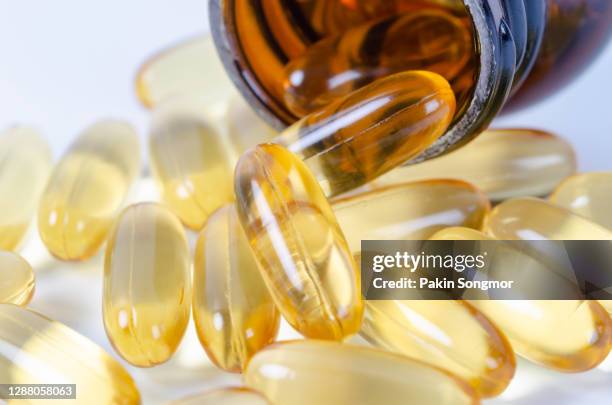 fish oil capsules on white background, healthy diet concept. - collagens stock pictures, royalty-free photos & images