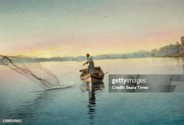 Iraq Euphrates River, fisherman throwing net, sunset scene. 1950, Iraq.