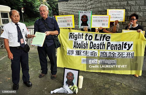 Amnesty activists hand a signed petition letter to a staff member outside the US consulate during a protest to mark the World Day Against the Death...