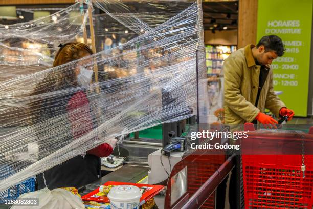 Supermarket cashier during the coronavirus epidemic in Eure. France.