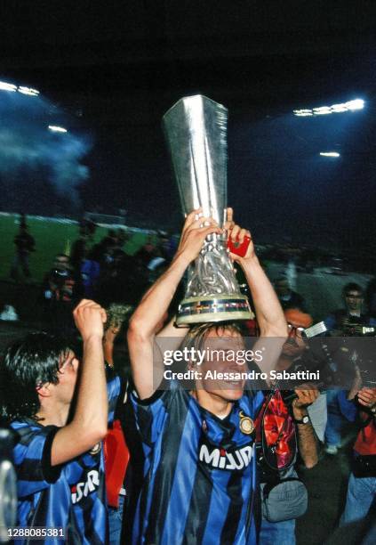 Jürgen Klinsmann of FC Internazionale celebrates the victory with the trophy after the Final UEFA Cup 1991 match between AS Roma and FC...