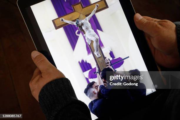 Coronavirus epidemic . Catholic mass on Ipad. France.