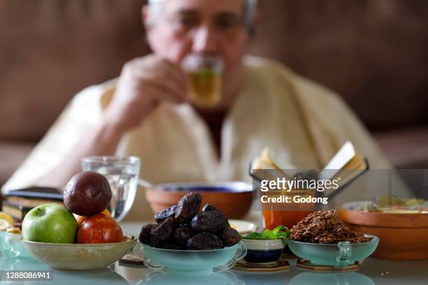 Traditional meal for iftar in time of Ramadan after the fast has been broken. Muslim drinking tea. France.
