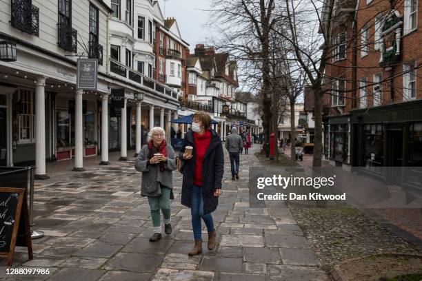 Members of the public walk through the Pantiles on November 27, 2020 in Royal Tunbridge Wells, United Kingdom. The UK Government announced a new tier...