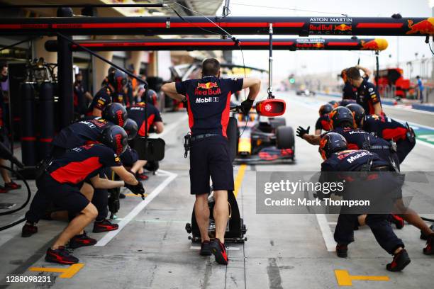 The Red Bull Racing team wait for Alexander Albon of Thailand driving the Aston Martin Red Bull Racing RB16 to stop in the Pitlane during practice...