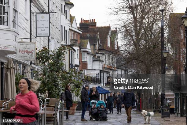 Members of the public walk through the Pantiles on November 27, 2020 in Royal Tunbridge Wells, United Kingdom. The UK Government announced a new tier...
