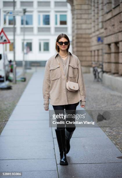 Jacqueline Zelwis is seen wearing Arket jacket in beige, Samsoe Samsoe jumper, Calvin Klein jeans, Bally bag, Saint Laurent sunglasses H&M boots on...