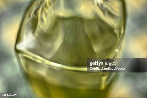 olive oil in an elegant glass bottle - olive oil ストックフォトと画像