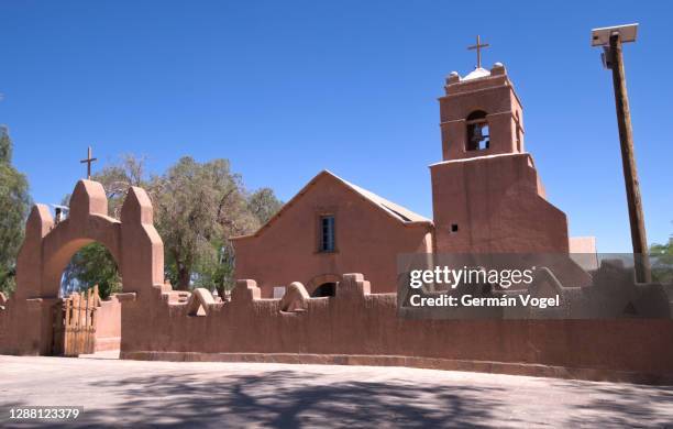 old adobe church gate and bell tower of san pedro de atacama, chile - san pedro de atacama stock-fotos und bilder