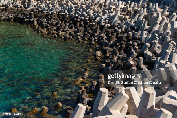 tetrapods on muscat coastline near corniche, oman - construction barrier stock pictures, royalty-free photos & images
