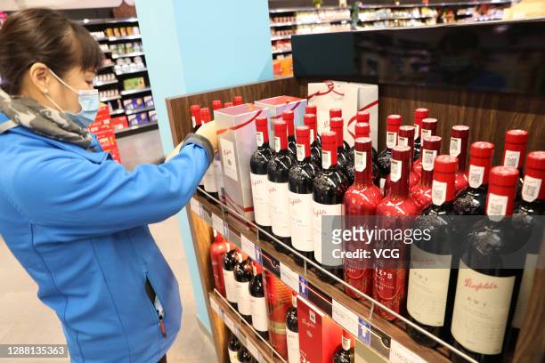 Bottles of wine imported from Australia are displayed for sale at a supermarket in Nantong Free Trade Zone on November 27, 2020 in Nantong, Jiangsu...