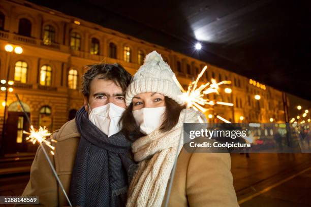 new normal: couple celebrating new year - czech republic covid stock pictures, royalty-free photos & images