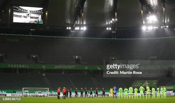 The players of Wolfsburg and Bremen stand for a minutes silence in memory of Argentinian football legend Diego Maradona during the Bundesliga match...
