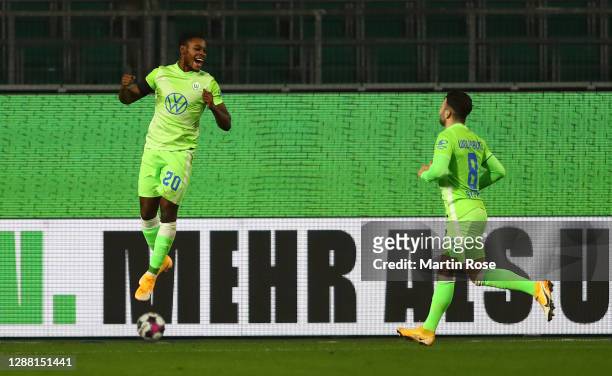 Ridle Baku of Wolfsburg celebrates scoring his goal with Renato Steffen during the Bundesliga match between VfL Wolfsburg and SV Werder Bremen at...
