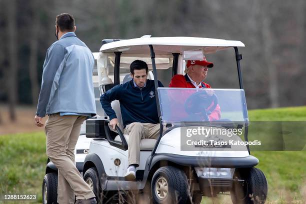 President Donald Trump drives his cart to Marine One after golfing at Trump National Golf Club on November 27, 2020 in Sterling, Virginia. President...