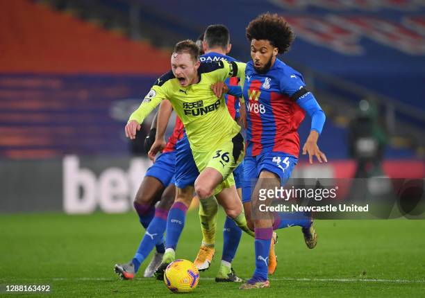 Sean Longstaff of Newcastle United is challenged by Scott Dann of Crystal Palace and Jairo Riedewald of Crystal Palace on the edge of the box leading...