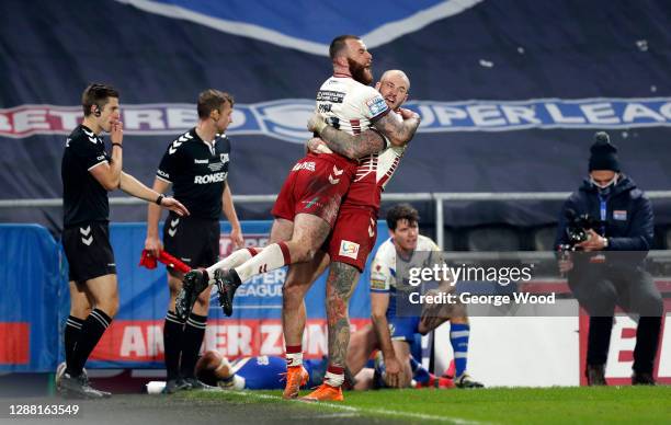 Jake Bibby of Wigan Warriors celebrates with Zak Hardaker of Wigan Warriors after scoring his side's first try during the Betfred Super League Grand...