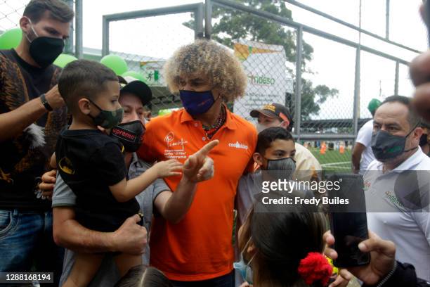 Former captain of the Colombian soccer team, Carlos "El Pibe" Valderrama poses for photos with fans during the re-inauguration of the Maria...