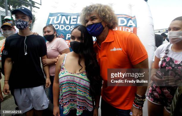 Former captain of the Colombian soccer team, Carlos "El Pibe" Valderrama poses for photos with fans during the re-inauguration of the Maria...