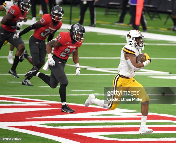 Running back Xazavian Valladay of the Wyoming Cowboys runs for a 78-yard touchdown against the UNLV Rebels in the first half of their game at...