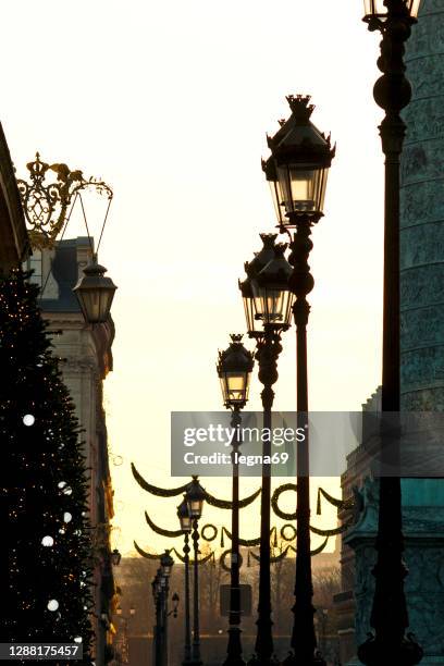 sunset on paris: christmas decorations on place vendôme - paris christmas stock pictures, royalty-free photos & images