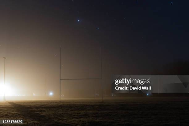 rugby posts, silhouetted against street lights. on a atmospheric, foggy winters night - rugby field stock pictures, royalty-free photos & images