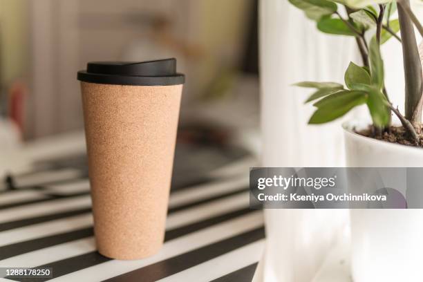 reusable glass coffee cup. travel mug with insulated silicone holder and splashproof lid takeaway drinking flask thats portable and lightweight. eco cup with coffee. - woodland cafe stock pictures, royalty-free photos & images