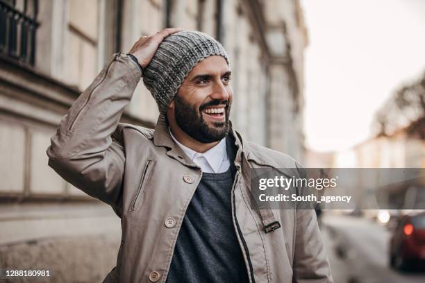 handsome fashionable man on the street - gorro-de-lã imagens e fotografias de stock