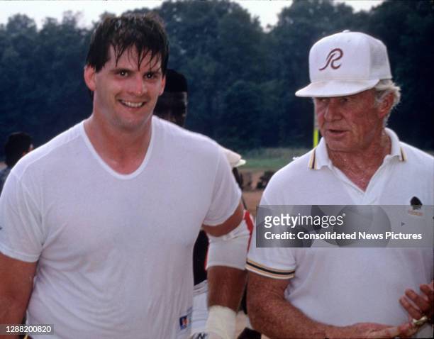 Washington Redskins offensive Tackle Jim Lachey, left, and Offensive Line Coach Jim Hanifan share some thoughts as they come off the field following...