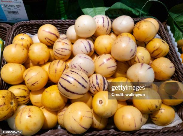 pepino melon for sale at supermarket - pepino stock-fotos und bilder