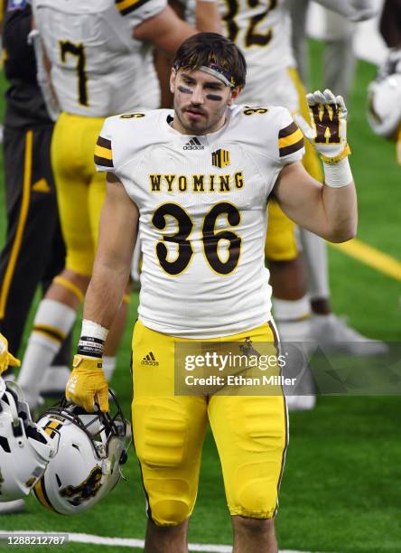 Linebacker Brennan Kutterer of the Wyoming Cowboys holds up four fingers at the start of the fourth quarter of a game against the UNLV Rebels at...