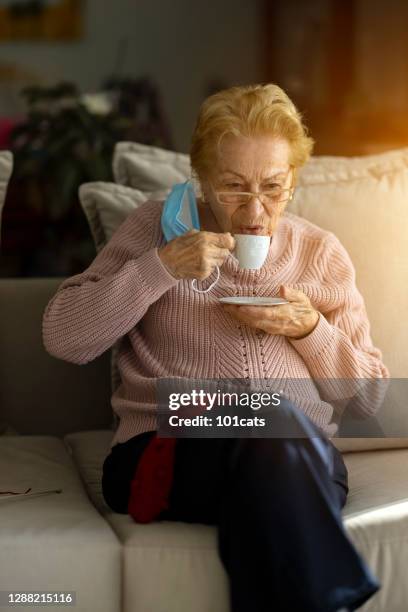 old woman drinking turkish coffee at home - turkish coffee drink stock pictures, royalty-free photos & images