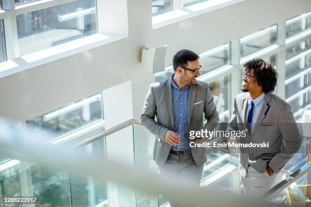 great ideas come from casual conversation - business man walking stock pictures, royalty-free photos & images